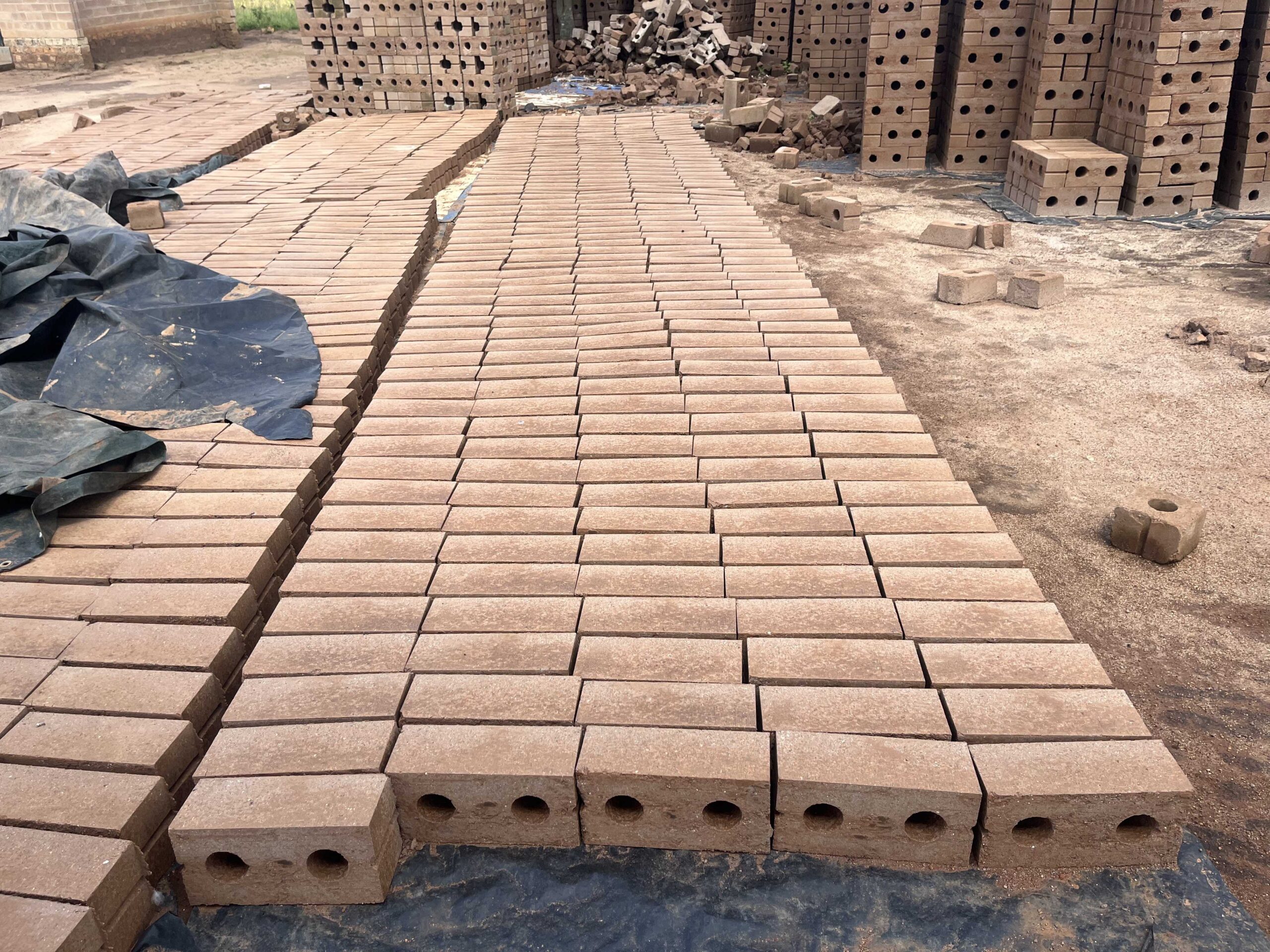 Tall residential skyscrapers with a modern design featuring a mix of teal and beige colors. The buildings have numerous windows and balconies, indicating high-density housing.